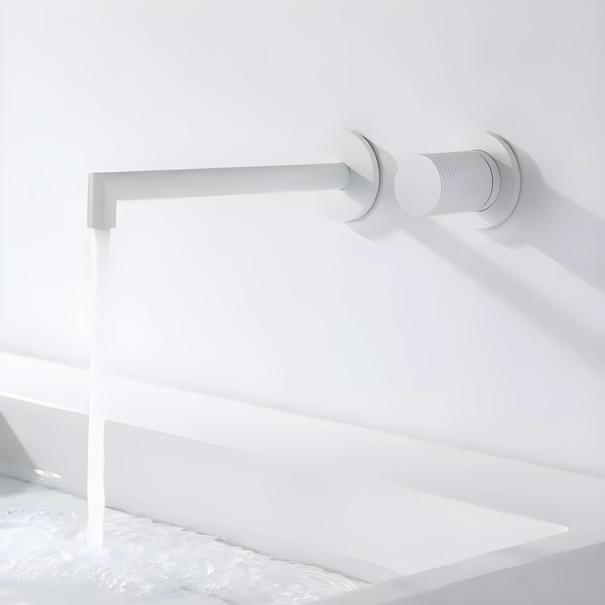 A wall-mounted knurled brass mixer tap faucet with a long spout and round handles.