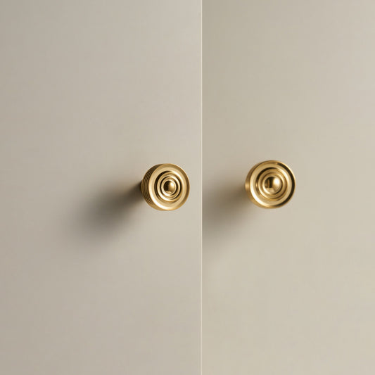 EPIDAVROS ribbed knobs in Polished Gold on cream cabinet doors