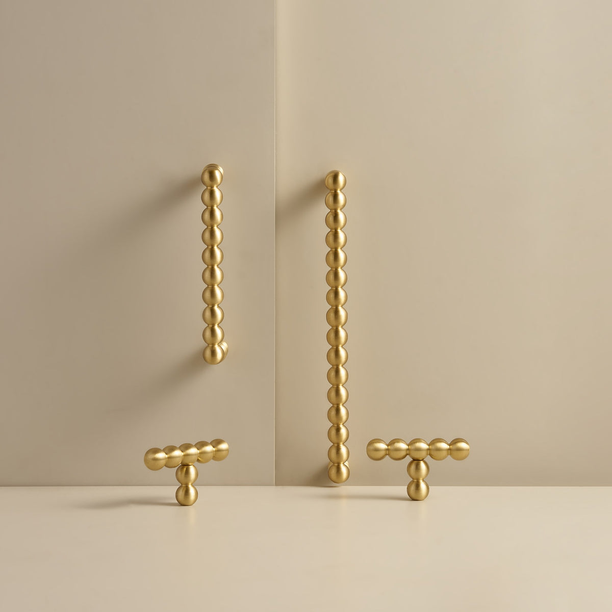 KOMBOLOI beaded brass handles and T-pulls in Satin Brass, studio scene