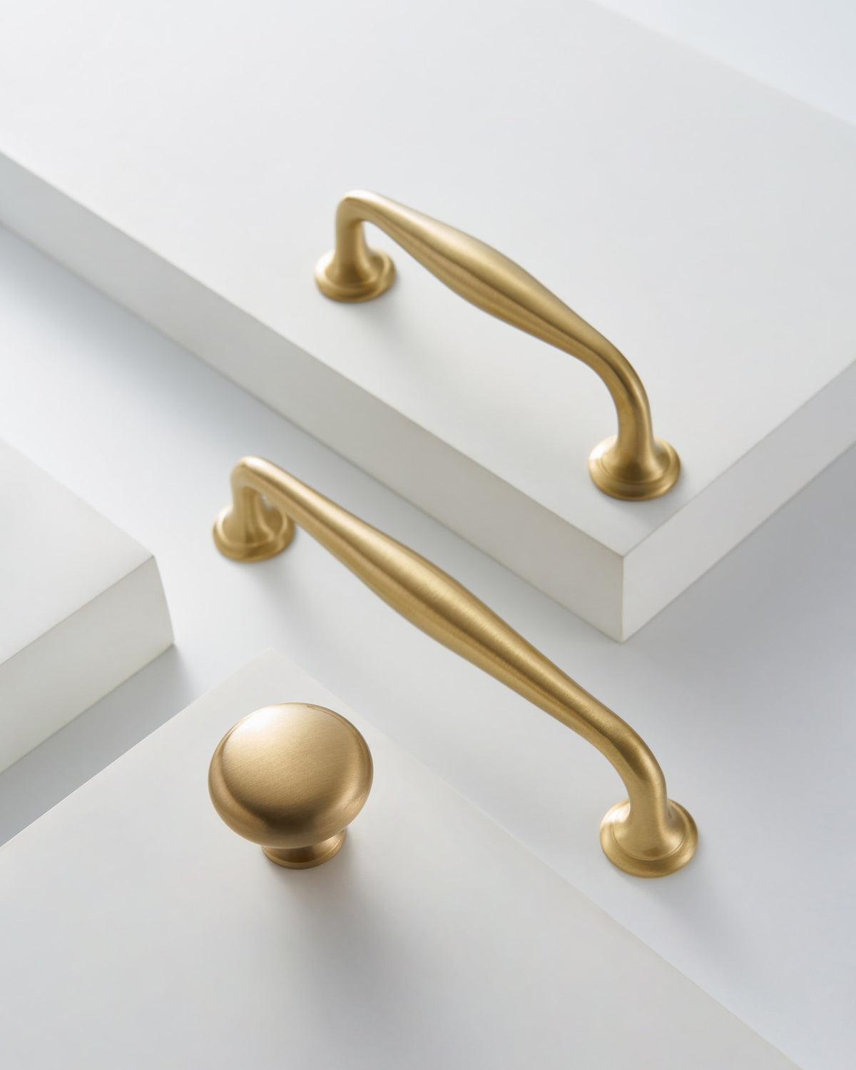 NAFPLIO brass handles and round knob on white cabinetry