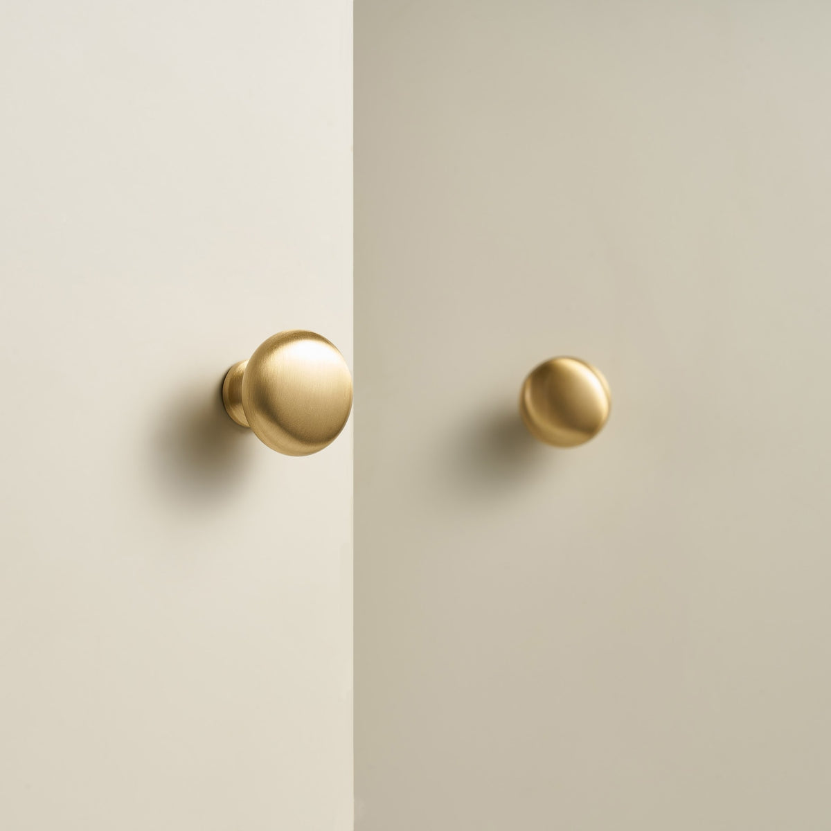 NAFPLIO brass round knobs on cream cabinet doors