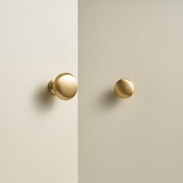 NAFPLIO brass round knobs on cream cabinet doors
