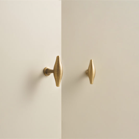 NAFPLIO brass T-knobs on cream cabinet doors