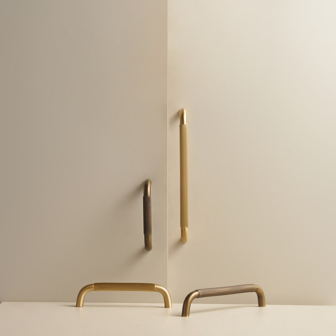 NEMEA reeded brass handles in Satin Brass and Antique Brass on cabinet doors and a stone plinth