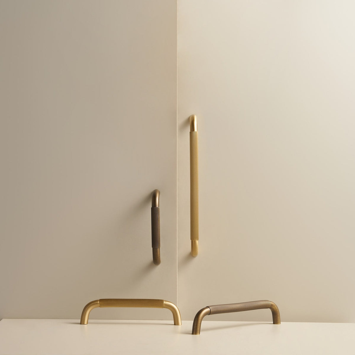 NEMEA reeded brass handles in Satin Brass and Antique Brass on cabinet doors and a stone plinth
