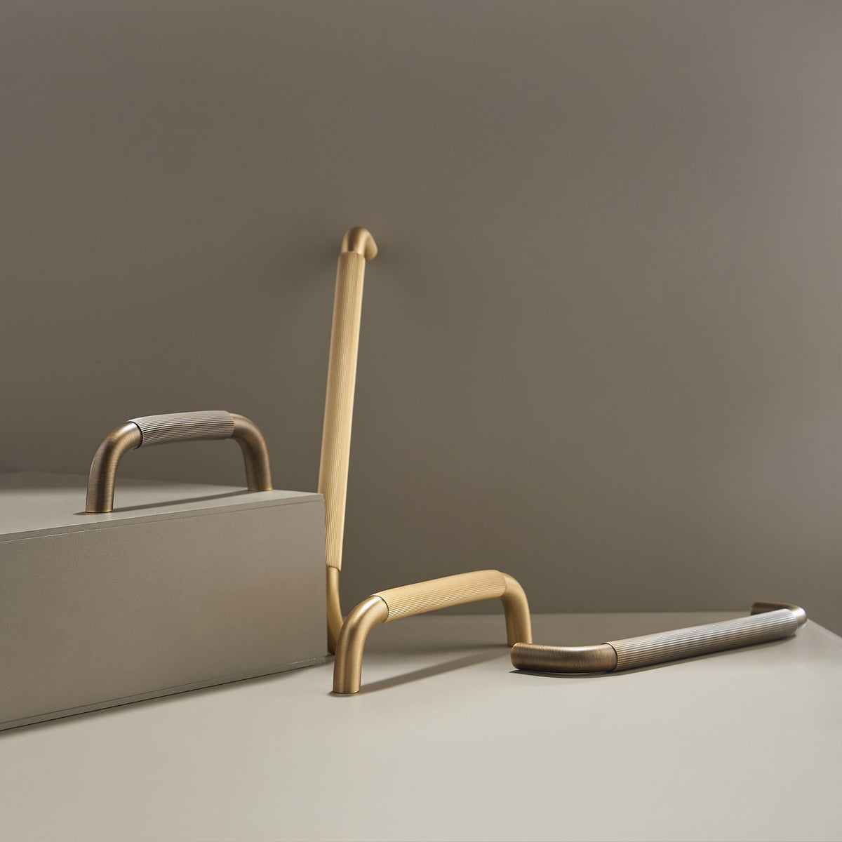 NEMEA reeded brass handles in Satin Brass and Antique Brass in a studio scene