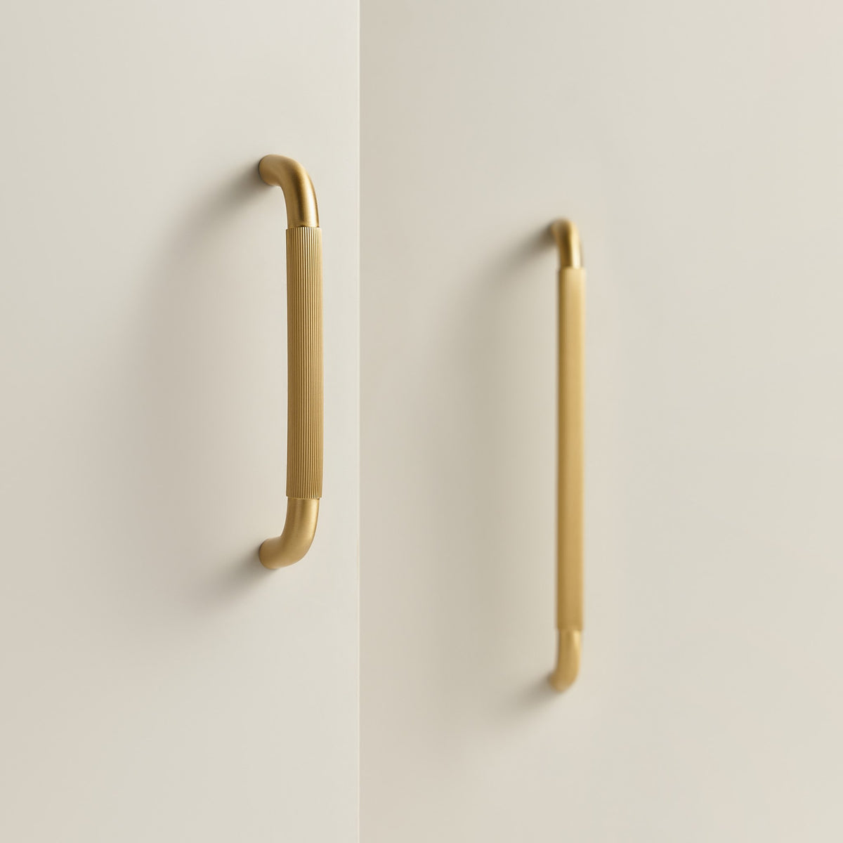 NEMEA reeded brass handles in Satin Brass on cream cabinet doors