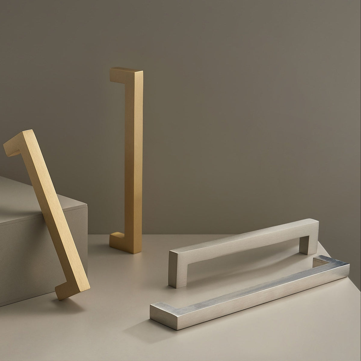 OIA square brass handles in Satin Brass and Brushed Nickel in a studio scene