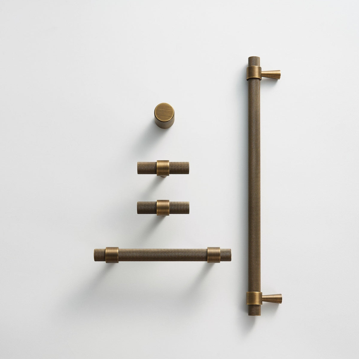OPORTO knurled handles and T-pulls in Antique Brass, flat lay