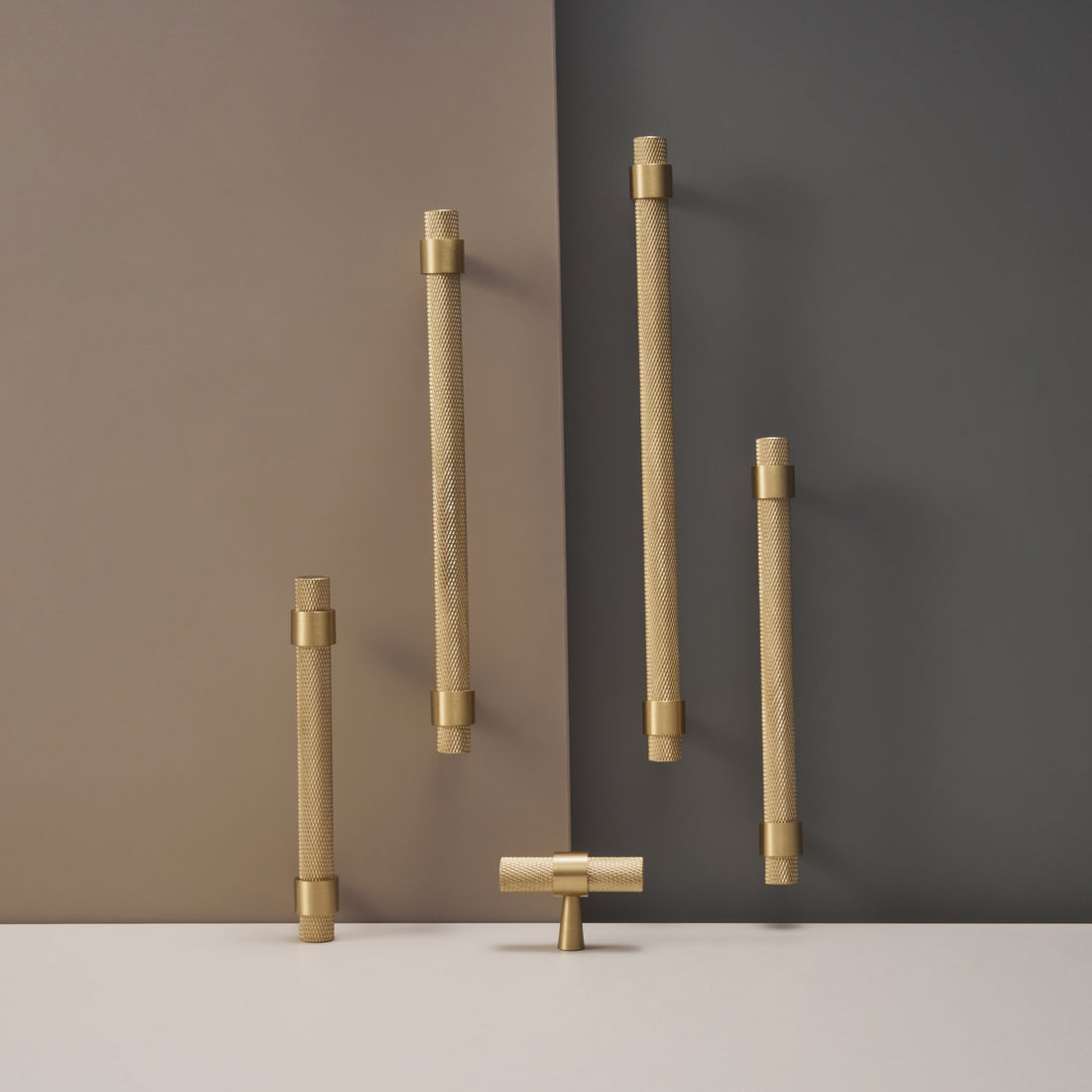 OPORTO handles and T-pulls in Satin Brass and black with brass posts, flat lay