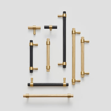 OPORTO handles and T-pulls in Satin Brass and black with brass posts, flat lay