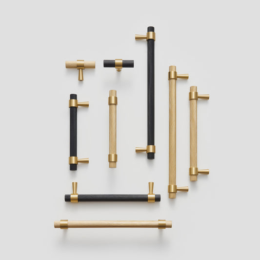 OPORTO handles and T-pulls in Satin Brass and black with brass posts, flat lay