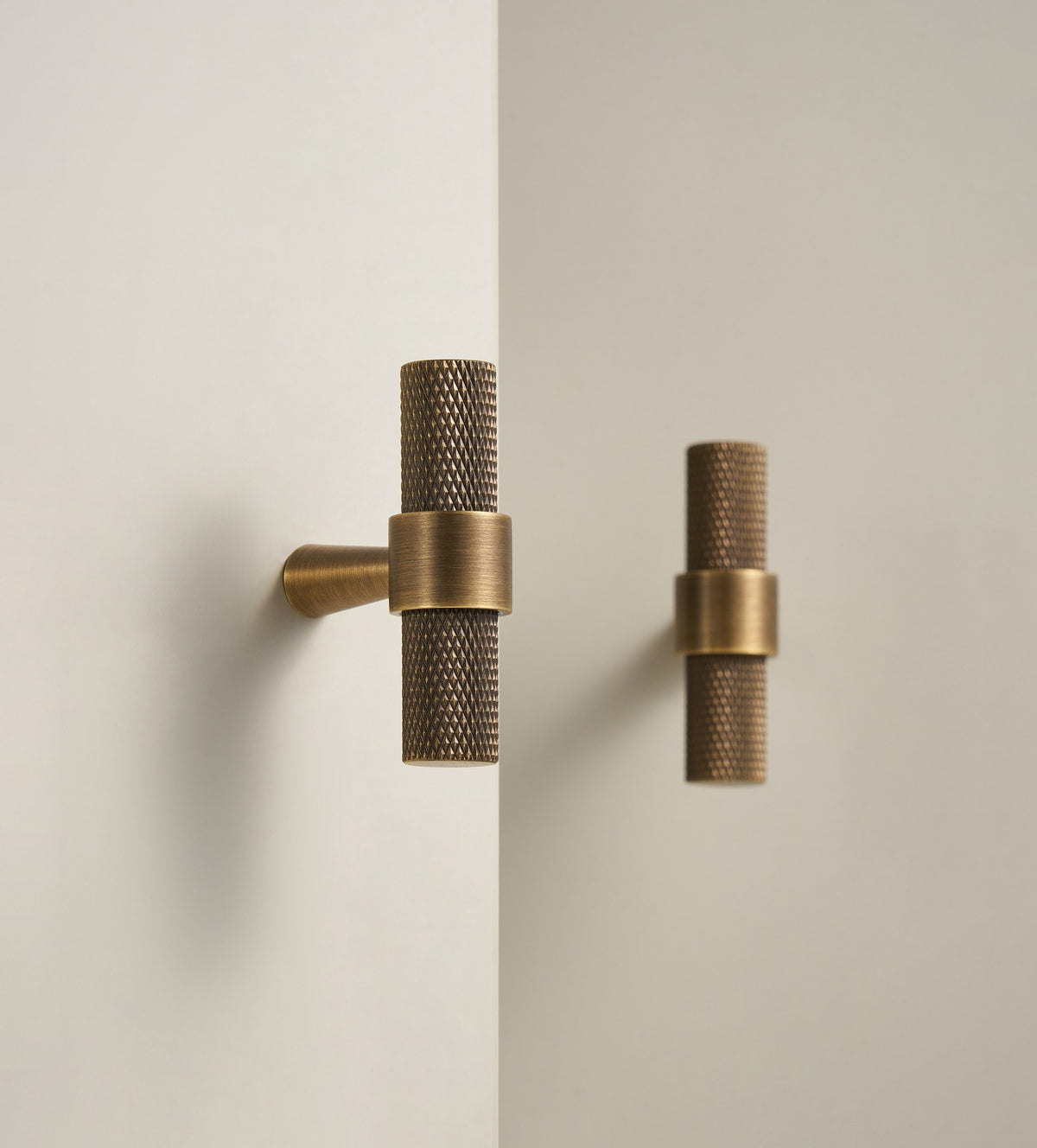 OPORTO knurled T-pulls in Antique Brass on cabinet doors