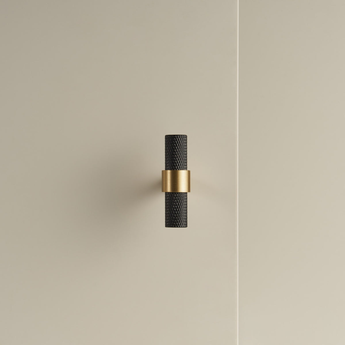 OPORTO knurled T-pull, black bar with Satin Brass post, on a cabinet door