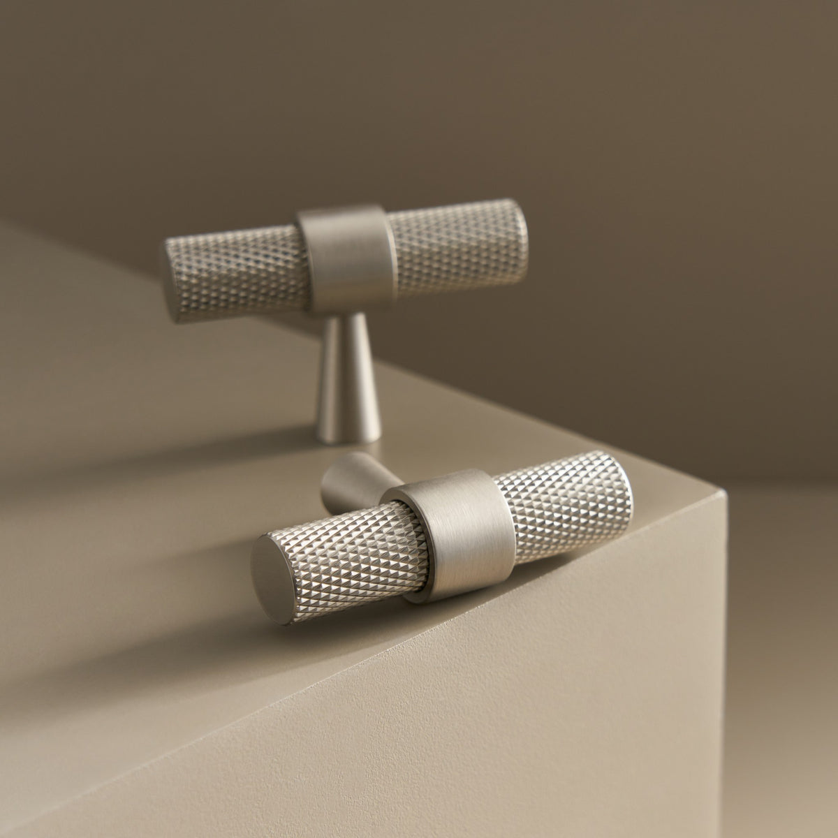 OPORTO knurled T-pulls in Brushed Nickel on a ledge