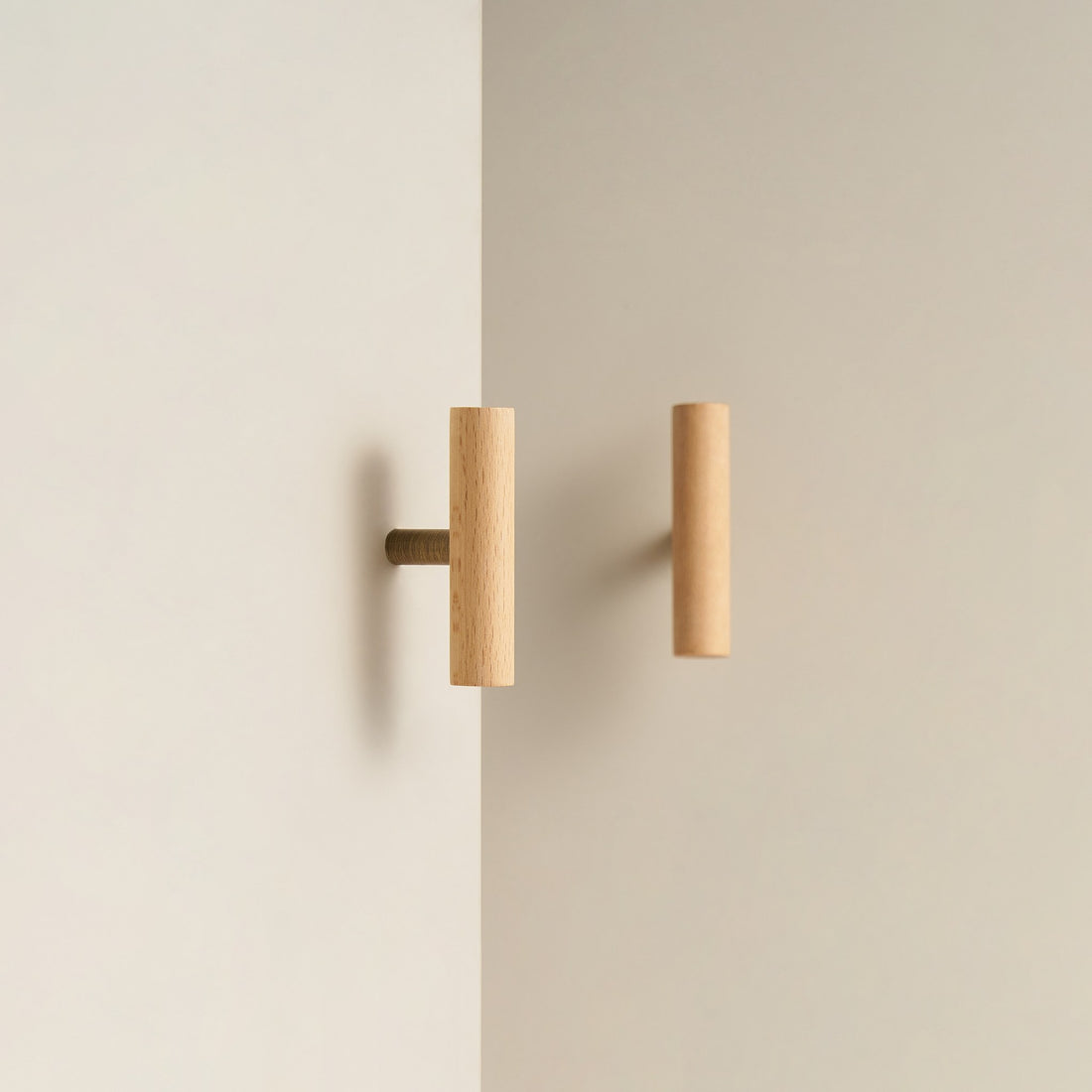 PILIO beech wood T-pull with Satin Brass post on a cabinet door