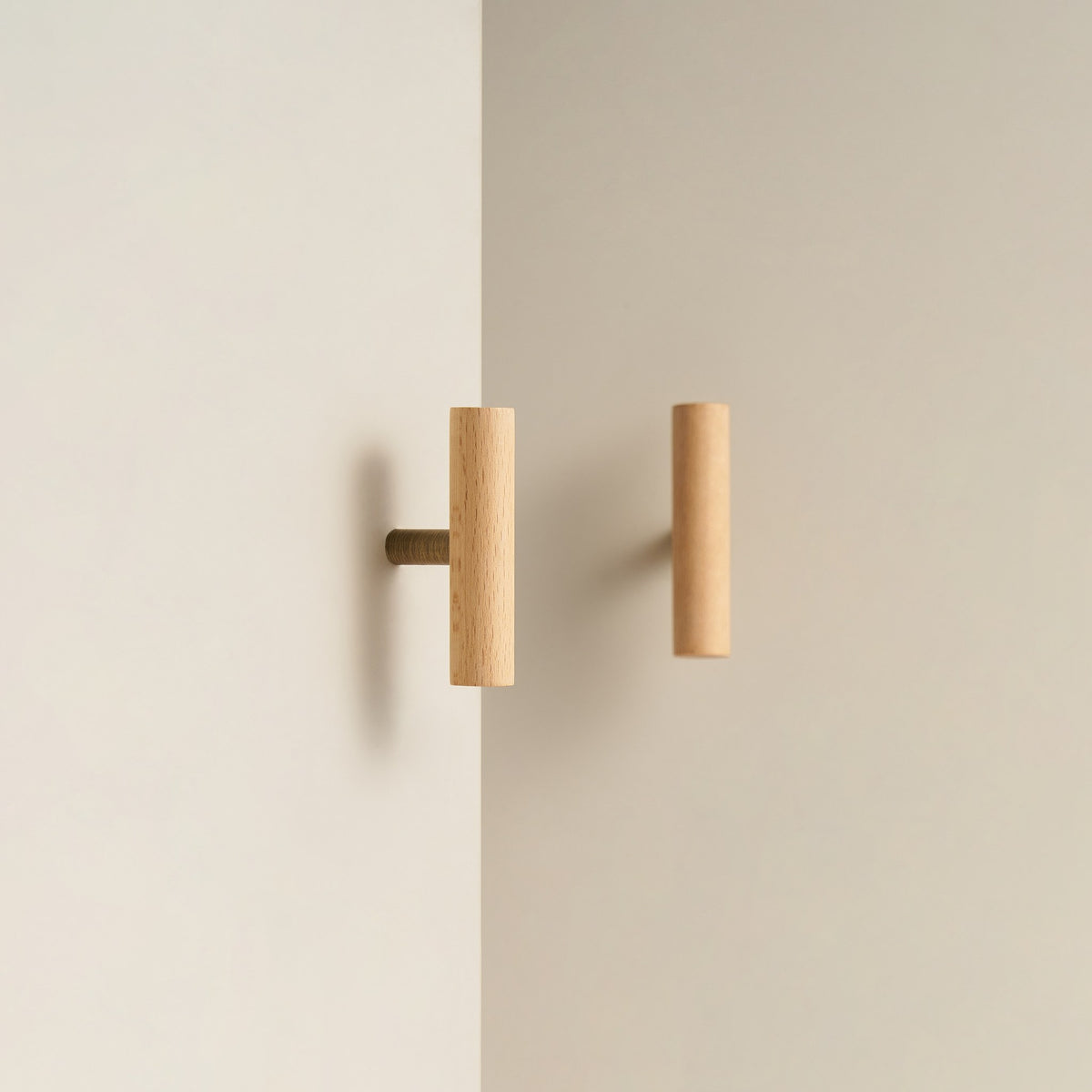 PILIO beech wood T-pull with Antique Brass post on a cabinet door