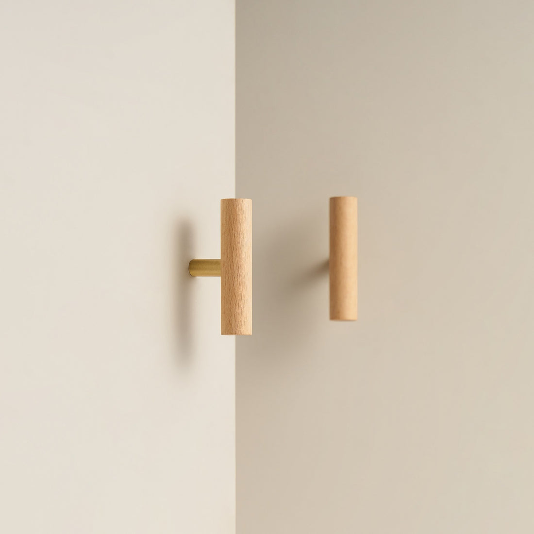 PILIO beech wood T-pull with Satin Brass post on a cabinet door