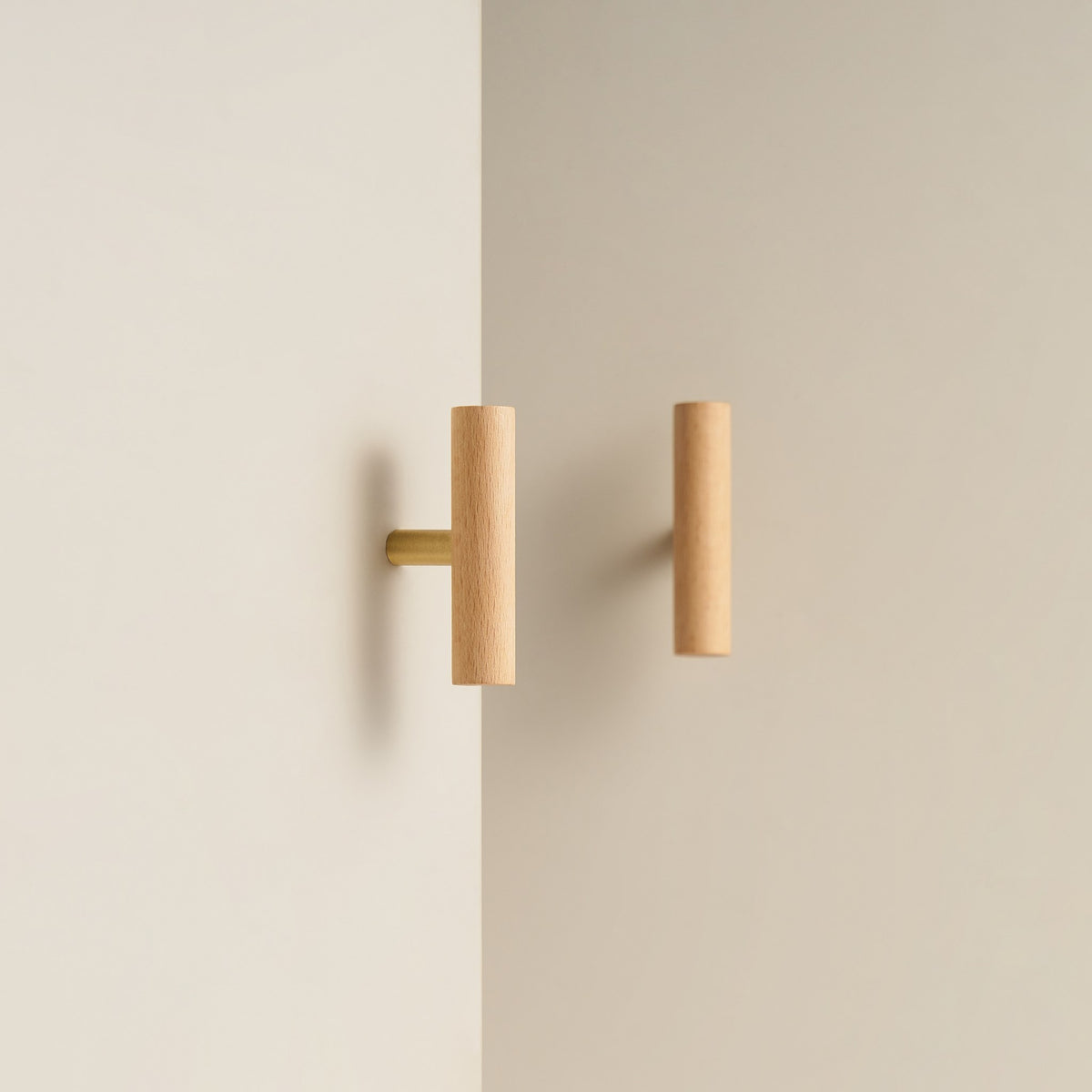 PILIO beech wood T-pull with Satin Brass post on a cabinet door