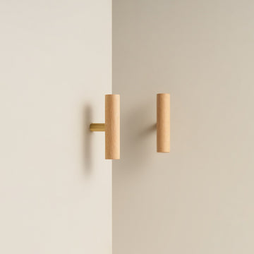 PILIO beech wood T-pull with Satin Brass post on a cabinet door