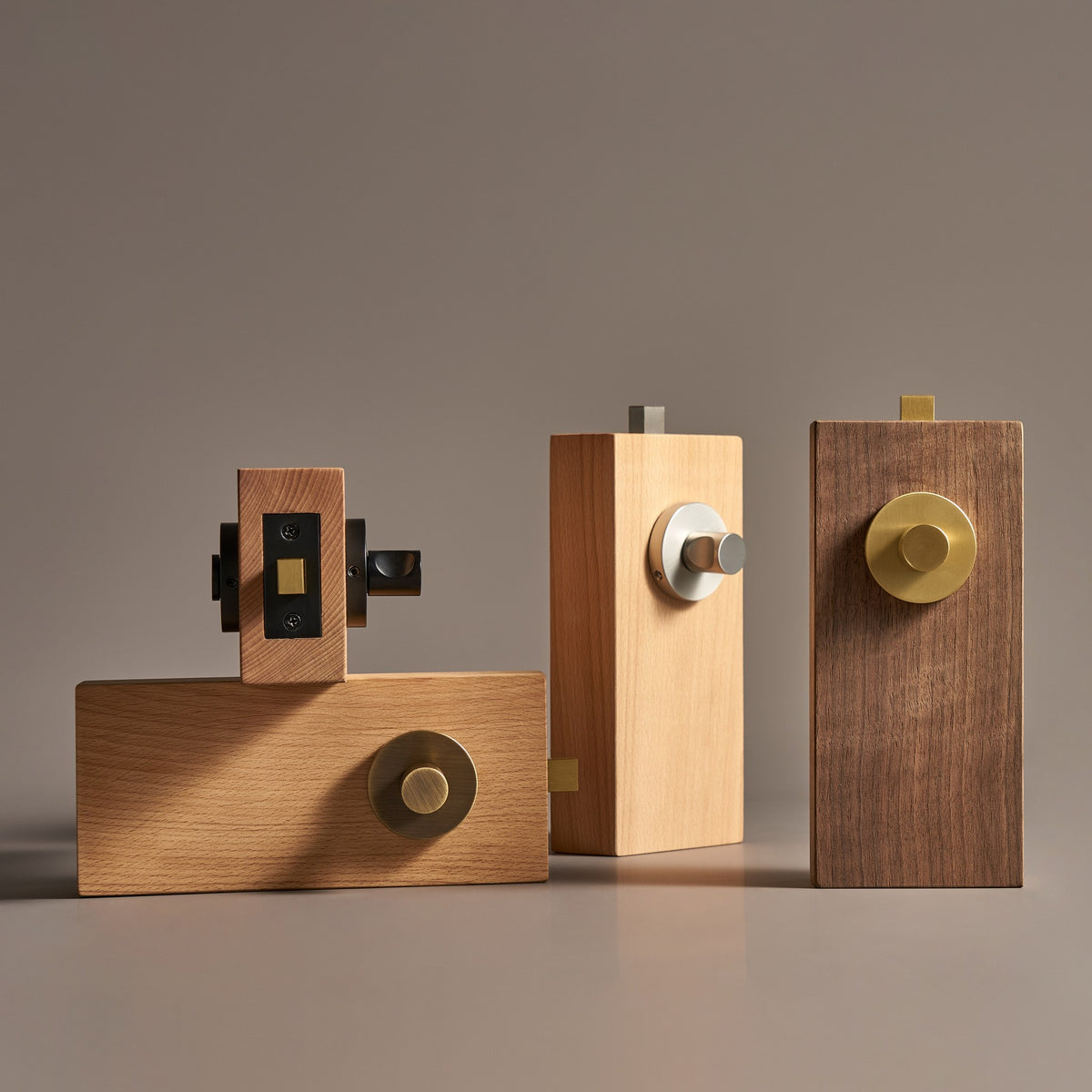 SIFNOS privacy thumbturns in Matte Black, Antique Brass, Brushed Nickel and Satin Brass on wood door samples